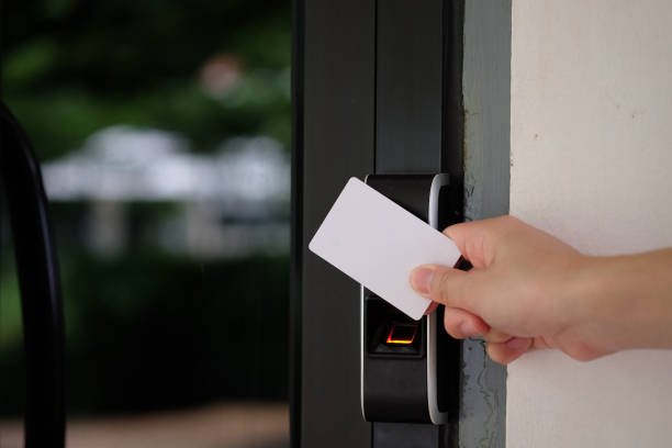 Electronic key access system with hand inserting key card to unlock door.